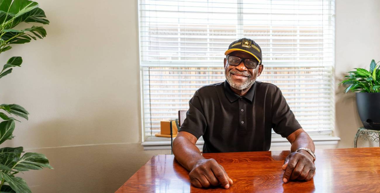 Smiling Veteran at home learning about trusted in-home care and support services from Help at Home.