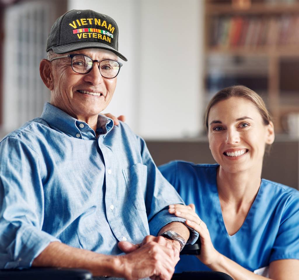 Caregiver providing companionship and personal support to a Veteran at home, showcasing Help at Home's trusted, Veteran-centered care.